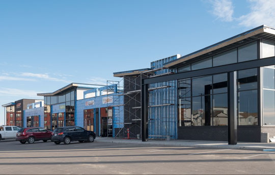 Hard hat and design plans on an income property construction site financed by Banner Bank