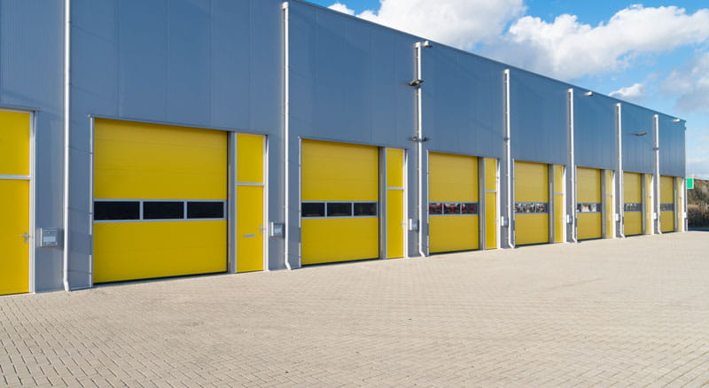 Warehouse garage bays with yellow doors financed with an income property permanent loan from Banner Bank