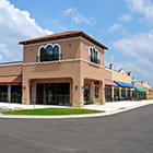 Stucco strip mall with blue and green awnings
