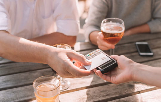 Patron pays for drinks with contactless card reader