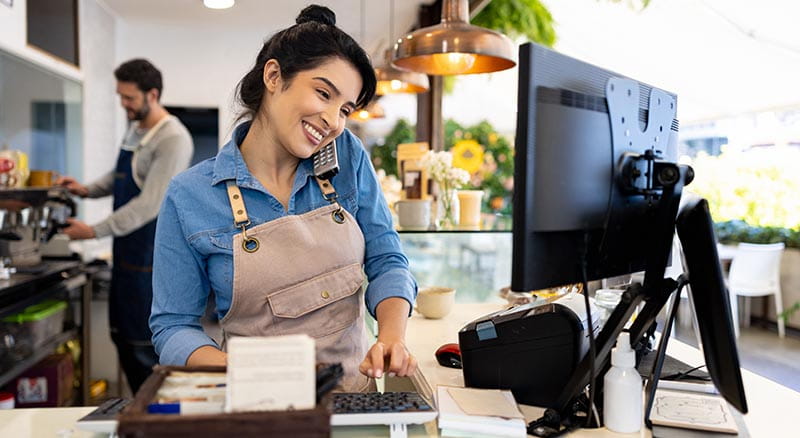 Person in shop on the phone at a computer