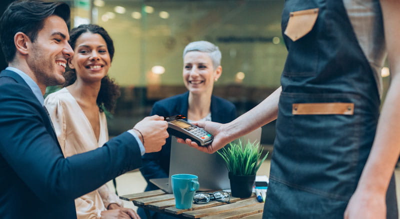 Business person pays with contactless credit card