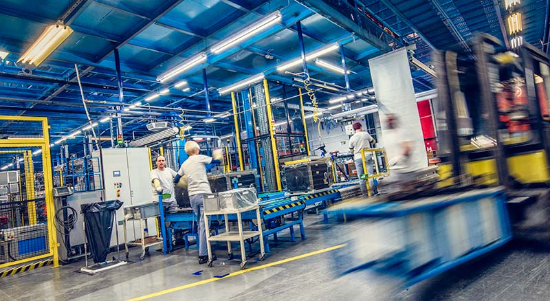 Large factory with lots of machinery and a forklift
