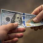 Handoff of a $100 bill