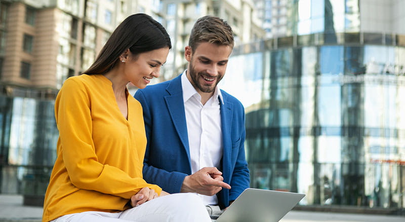 two business people review documents together