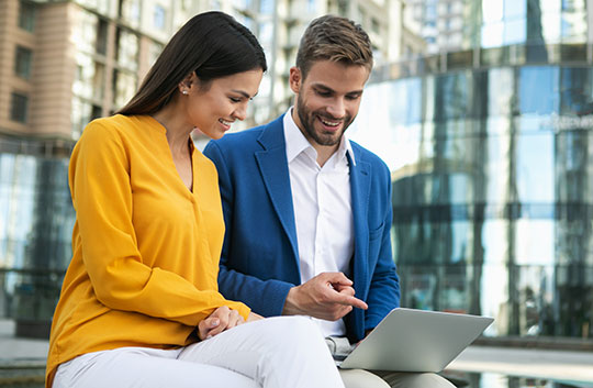 two business people review documents together