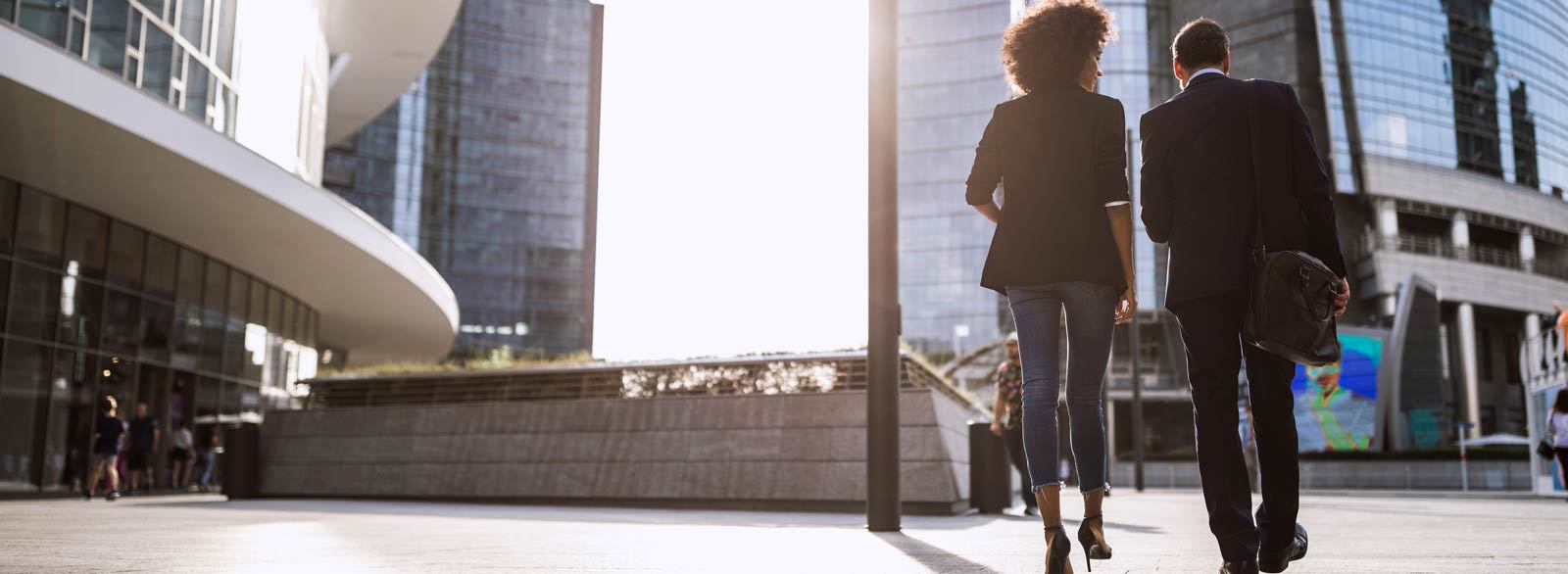 Business people walk to office building