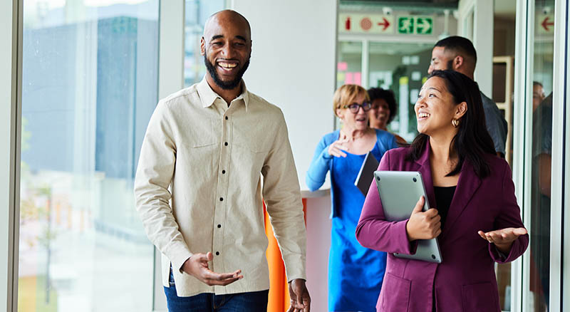 Group of colleagues walking and smiling