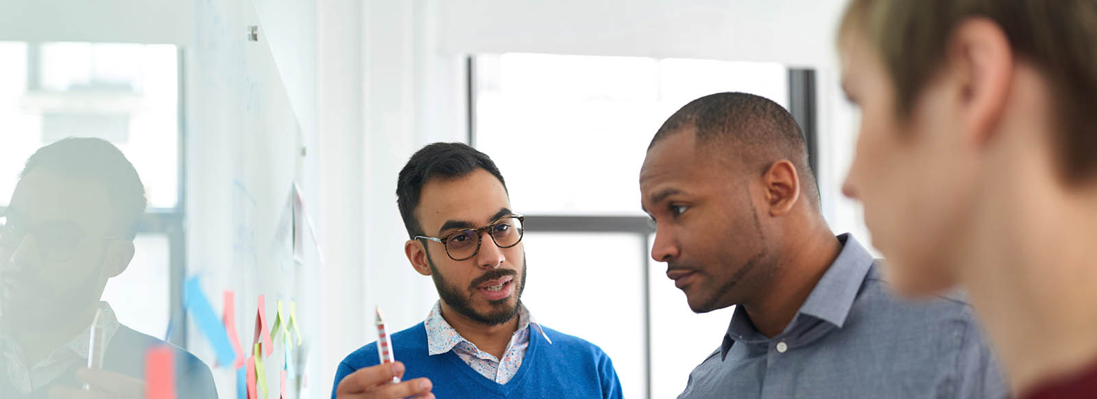 Three colleagues at a white board