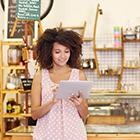 Woman holding tablet in her small shop