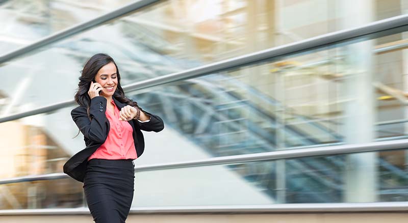Person walking while on the phone and looking at watch