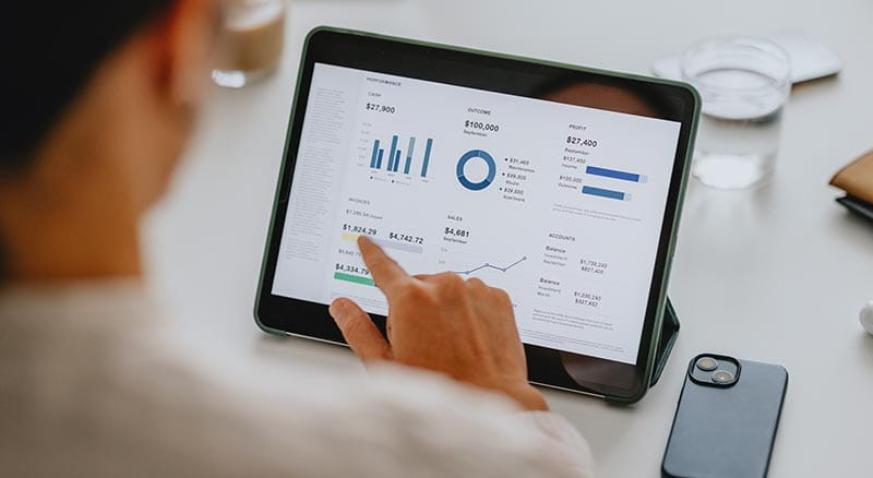 Person looking at reports on tablet