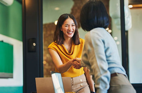 Businesswomen shaking hands