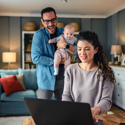 family of three looking at a computer