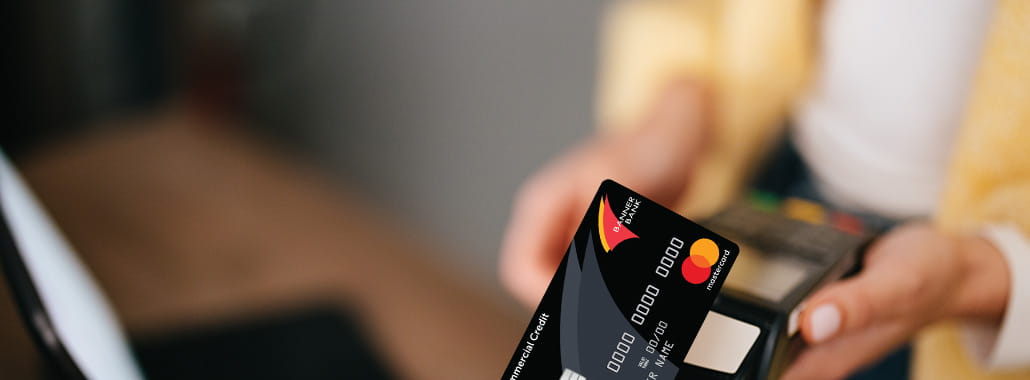 Person paying with Commercial Mastercard
