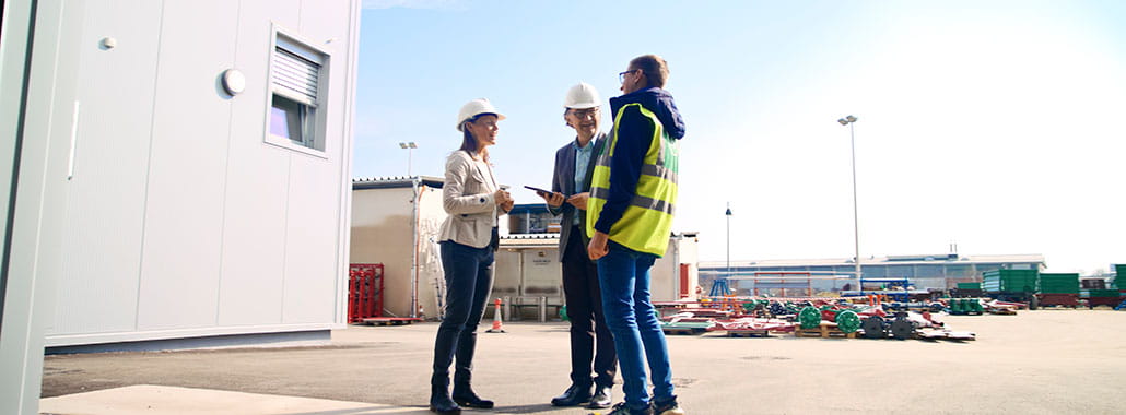 Group of colleagues in the entrance of a large warehouse