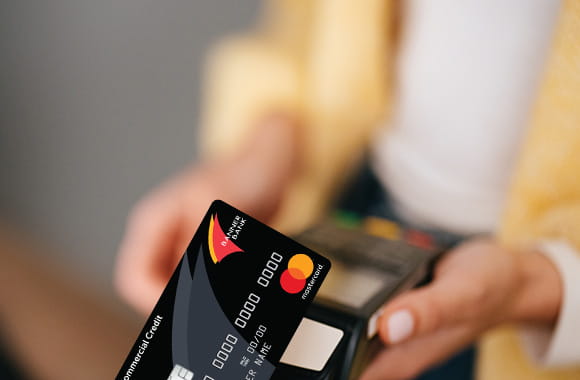 Person paying with Commercial Mastercard