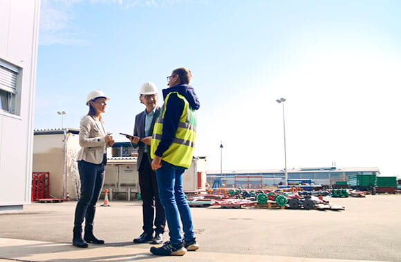 Group of colleagues in the entrance of a large warehouse