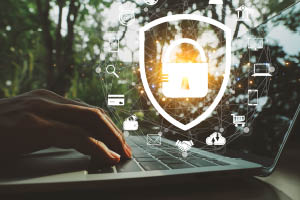 person typing on computer with a lock icon overlaying the image