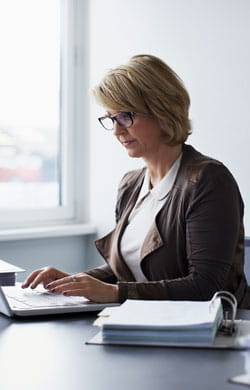 Business woman uses laptop