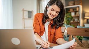 A woman sitting at a table taking notes