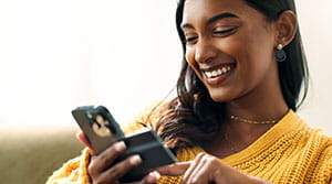 Person holding card and mobile phone