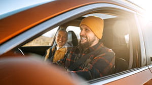 Two people smiling in a car