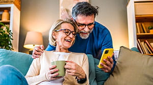 Two people looking at a cell phone