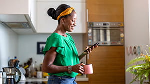 Person looking at phone in kitchen
