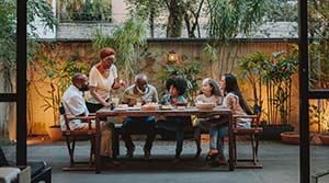 Family sitting at a table on the porch