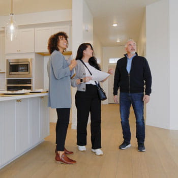 Couple looks at home with realtor