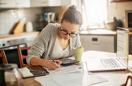 Person budgeting and paying bills at home