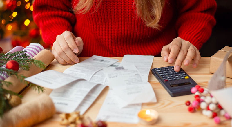 Person with calculator looking at receipts and papers