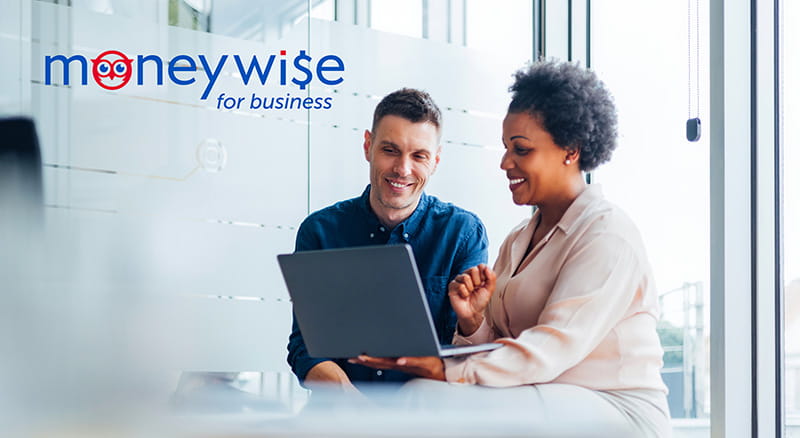 Two people looking at a laptop in an office with MoneyWise for Business logo
