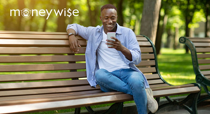 Person using phone on a bench with Moneywise logo
