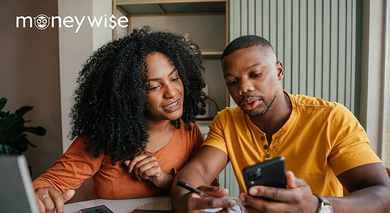 Two people looking at a phone with Moneywise logo
