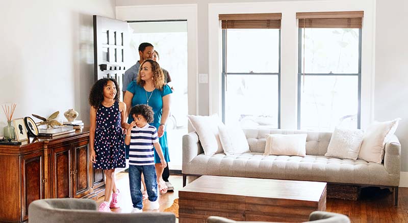 Family entering a staged home to tour