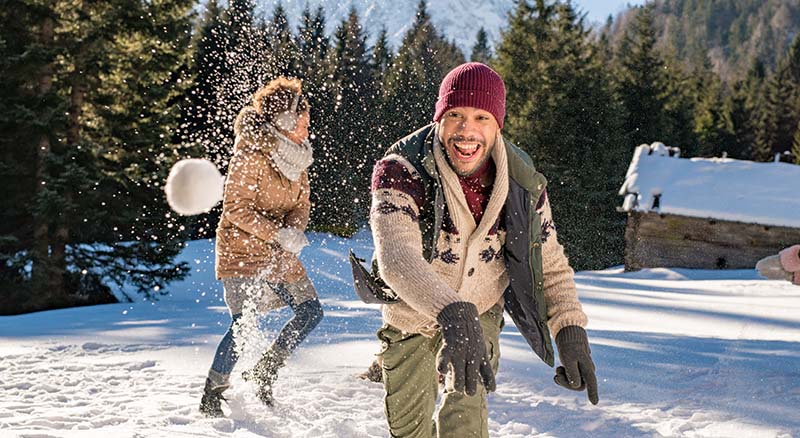 People having a snowball fight in the snow