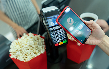 Digital wallet in use to pay for popcorn