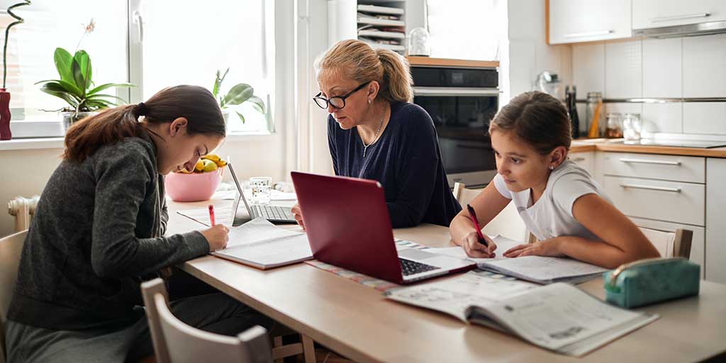 Family working and studying at dinner table