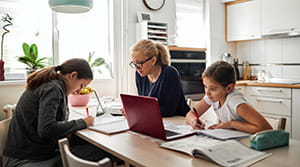 Family working and studying at dining table