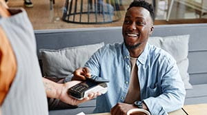 Person using phone to pay at a cafe