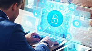 Caucasian male sitting at a laptop with a blue holographic screen and a large image of a padlock