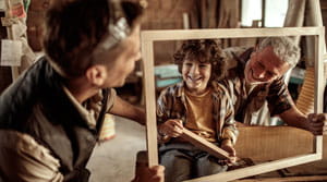 Father, son and grandfather build a frame