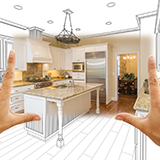 Hands framing a kitchen as person pictures the room after a renovation
