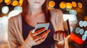 Woman holding a phone and credit card