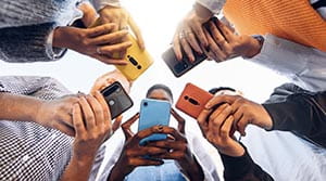 5 people side by side all using phones