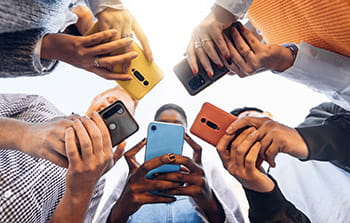 Group of people using cell phones in a circle
