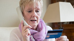 Person giving credit card info on the phone