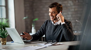 Person on phone while at computer